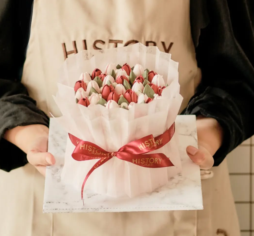 Person holding a flower bouquet